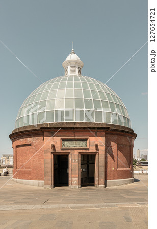 the iconic entrance to the Greenwich Foot Tunnel are characterized by their elegant brickwork and glass domes. the iconic entrance to the Greenwich Foot Tunnel are characterized by their elegant brickwork and glass domes. 127654721