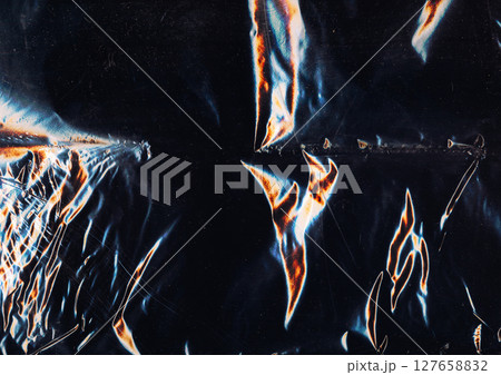 Creased overlay. Old film texture. Blue orange color light flare dust scratches used weathered rough foil noise dark black art abstract background. Creased overlay. Old film texture. Blue orange color light flare dust scratches used weathered rough foil noise dark black art abstract background. 127658832