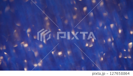 Defocused beam. Bokeh glow. Sparkling blue golden yellow shades lens flare on abstract blurred light background. Defocused beam. Bokeh glow. Sparkling blue golden yellow shades lens flare on abstract blurred light background. 127658864