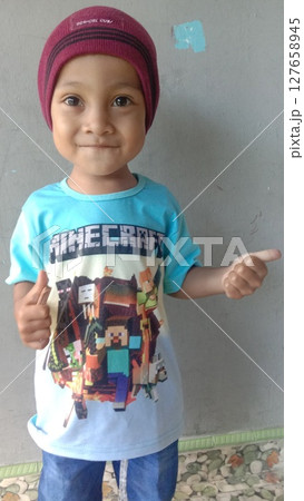 boy wearing maroon hat 127658945