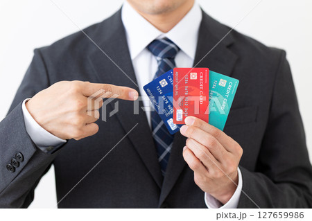 クレジットカードを指差すスーツ姿のビジネスマン男性 127659986