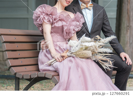 ピンクのドレスでウェディングフォトを撮るカップル 127660291