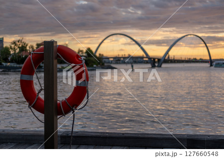 Elizabeth Quay during the sunset, a major waterfront precinct in Perth, Western Australia, situated on the Swan River. It is a hub for dining, entertainment and events. with swim ring on the foregroun 127660548