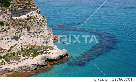 Tourists enjoying crystal clear turquoise water at Tropea beach, Calabria, Italy 127660701