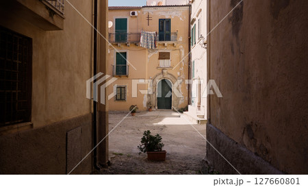 Exploring the charming alleys of Tropea, discovering hidden courtyards and ancient buildings Exploring the charming alleys of Tropea, discovering hidden courtyards and ancient buildings 127660801