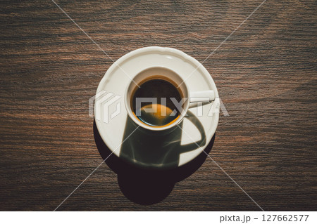 espresso in a cup on a wooden table top view. espresso in a cup on a wooden table top view. 127662577
