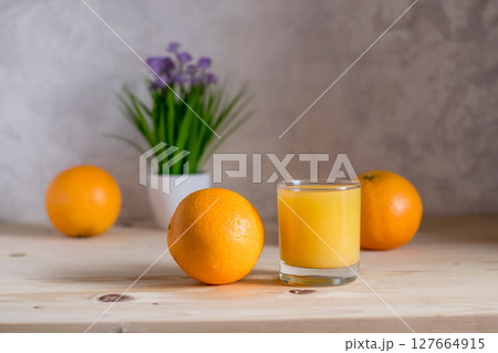 Orange reflects natural light on the kitchen table Orange reflects natural light on the kitchen table 127664915