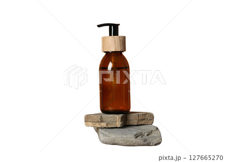 Amber bottle resting on two stacked stones, isolated on white, PNG Amber bottle resting on two stacked stones, isolated on white, PNG 127665270