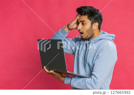 Displeased Indian man use laptop surprised by bad news, fortune loss, game fail, lottery results Displeased Indian man use laptop surprised by bad news, fortune loss, game fail, lottery results 127665992