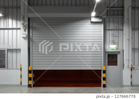 Shutter door in factory warehouse suit for industrial background. 127666778