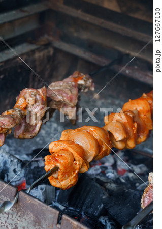 Traditional Argentinian Asado: Rotisserie Grilled Meat Skewers over Charcoal with Rich Smoky Flavors and Rustic Grilling Setup Traditional Argentinian Asado: Rotisserie Grilled Meat Skewers over Charcoal with Rich Smoky Flavors and Rustic Grilling Setup 127667130