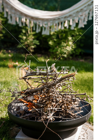 Cozy Backyard Retreat with Fire Pit, Hammock, and Greenery: Relaxing Summer Scene with Warm Lighting, Rustic Texture, and Peaceful Ambience Cozy Backyard Retreat with Fire Pit, Hammock, and Greenery: Relaxing Summer Scene with Warm Lighting, Rustic Texture, and Peaceful Ambience 127667131