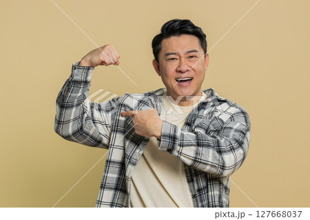 Happy man looking confident showing biceps feeling power strength to fight for rights success win Happy man looking confident showing biceps feeling power strength to fight for rights success win 127668037