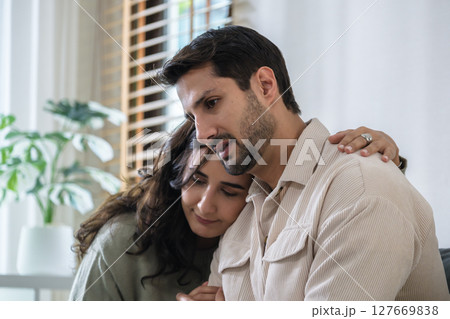 Supportive couple in emotional moment at home as woman struggles with sadness and stress, expressing Supportive couple in emotional moment at home as woman struggles with sadness and stress, expressing 127669838