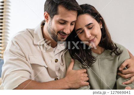 Supportive couple in emotional moment at home as woman struggles with sadness and stress, expressing Supportive couple in emotional moment at home as woman struggles with sadness and stress, expressing 127669841