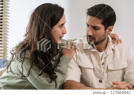Supportive couple in emotional moment at home as woman struggles with sadness and stress, expressing Supportive couple in emotional moment at home as woman struggles with sadness and stress, expressing 127669842