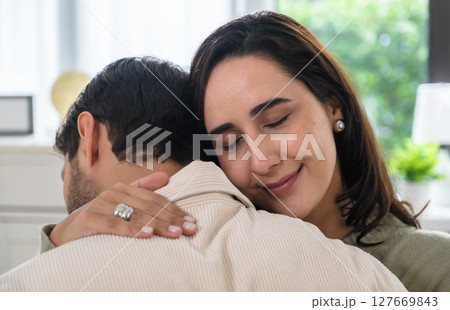 Supportive couple in emotional moment at home as woman struggles with sadness and stress, expressing Supportive couple in emotional moment at home as woman struggles with sadness and stress, expressing 127669843
