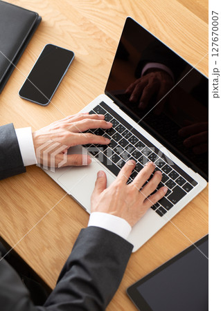 デスクでパソコン仕事をするスーツ姿のミドル男性ビジネスマン 127670007