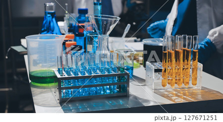 Scientist pipetting medical samples into microplate in laboratory 127671251