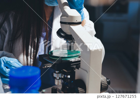 Scientist pipetting medical samples into microplate in laboratory Scientist pipetting medical samples into microplate in laboratory 127671255