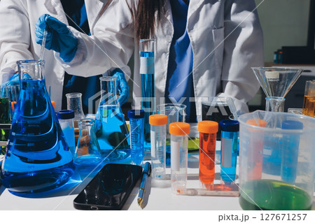 Scientist pipetting medical samples into microplate in laboratory Scientist pipetting medical samples into microplate in laboratory 127671257