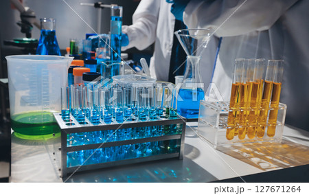 Scientist pipetting medical samples into microplate in laboratory Scientist pipetting medical samples into microplate in laboratory 127671264