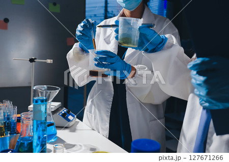 Scientist pipetting medical samples into microplate in laboratory Scientist pipetting medical samples into microplate in laboratory 127671266