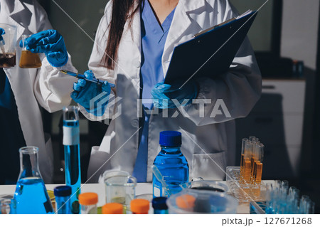 Scientist pipetting medical samples into microplate in laboratory Scientist pipetting medical samples into microplate in laboratory 127671268