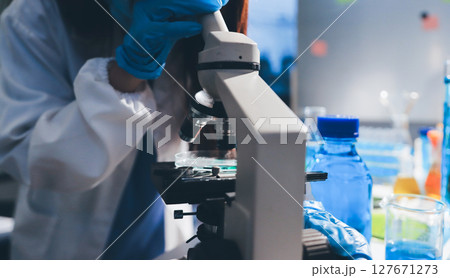 Scientist pipetting medical samples into microplate in laboratory Scientist pipetting medical samples into microplate in laboratory 127671273