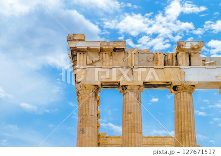 Parthenon pillars in front of blue and cloudy sky Parthenon pillars in front of blue and cloudy sky 127671517