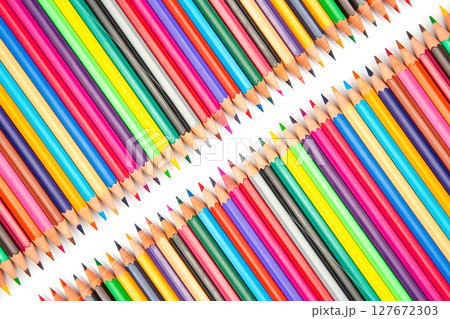 A close-up of colorful pencils in a row on a white surface. Perfect for creative design A close-up of colorful pencils in a row on a white surface. Perfect for creative design 127672303