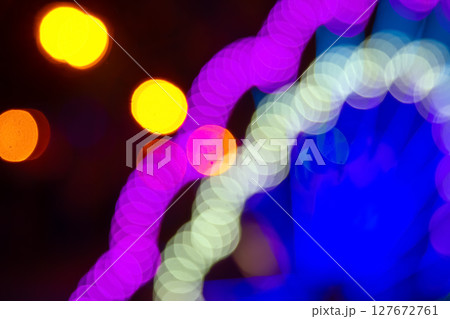 Abstract golden and vibrant light bokeh on a dark backdrop 127672761