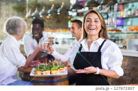 View on the Hispanic young lady holding tapas View on the Hispanic young lady holding tapas 127672807