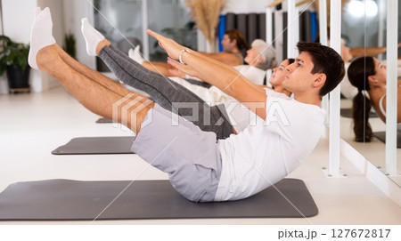 Young boy doing pilates in gym 127672817