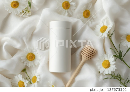 Chamomile and Honey Spa Product Concept on Soft White Fabric with Copy Space for Text Chamomile and Honey Spa Product Concept on Soft White Fabric with Copy Space for Text 127673392