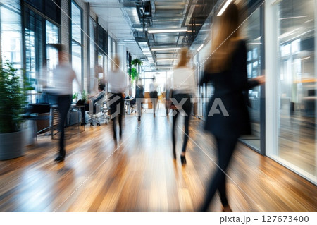 A busy office with people walking around and carrying briefcases 127673400