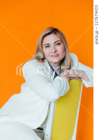 40 years old woman in white business suit at work 127674035