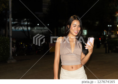 Asian Woman Using Smartphone at Night in City Asian Woman Using Smartphone at Night in City 127674165