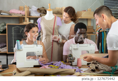 Participants in coterie practice sewing, chatting and talking, work with mannequin Participants in coterie practice sewing, chatting and talking, work with mannequin 127675442