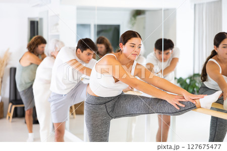 Young woman doing choreography at ballet barre Young woman doing choreography at ballet barre 127675477