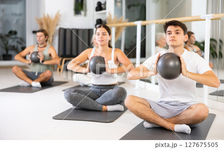 Group of different people doing exercises with ball Group of different people doing exercises with ball 127675505