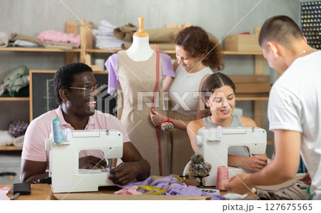 Participants in coterie practice sewing, chatting and talking, work with mannequin Participants in coterie practice sewing, chatting and talking, work with mannequin 127675565