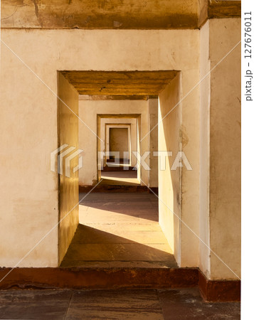 Ancient sandstone portal with arch, creating a passage through time. Symmetrical doorway, light and Ancient sandstone portal with arch, creating a passage through time. Symmetrical doorway, light and 127676011