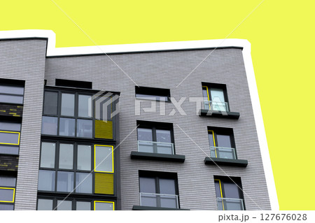 Building corner with modern apartment architecture. Yellow facade with geometric windows and Building corner with modern apartment architecture. Yellow facade with geometric windows and 127676028