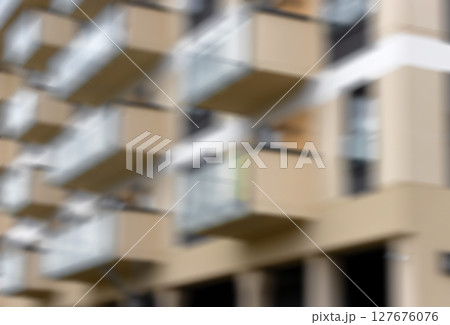 Defocused modern apartment building with abstract repetition of balconies and windows. Soft vertical Defocused modern apartment building with abstract repetition of balconies and windows. Soft vertical 127676076