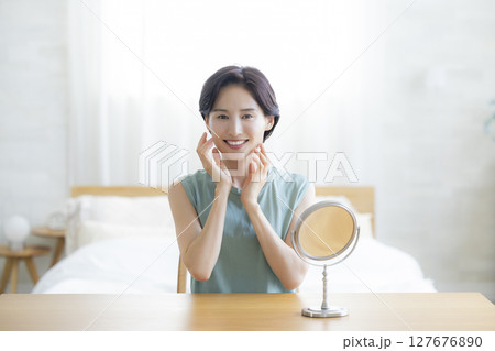 スキンケアをする寝室の女性 127676890