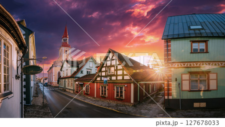 Parnu, Estonia. Puhavaimu Street With Old Wooden Houses, Restaurants, Cafe, Hotels And Shops During Sunrise. Lutheran Church Of St. Elizabeth 127678033