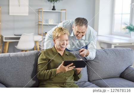 Elderly Couple Enjoying Online Leisure With Tablet Pc At Home Elderly Couple Enjoying Online Leisure With Tablet Pc At Home 127678116