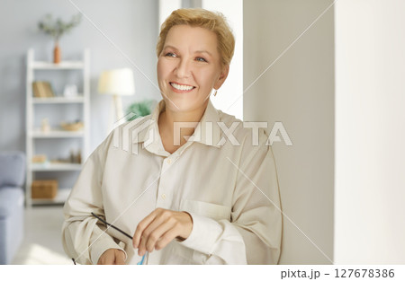 Smiling pleasant middle aged mature happy woman portrait, looking at camera, old attractive Smiling pleasant middle aged mature happy woman portrait, looking at camera, old attractive 127678386