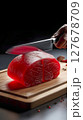 A transparent piece of meat, cut in half, like a crystal with a faceted surface, 127678709